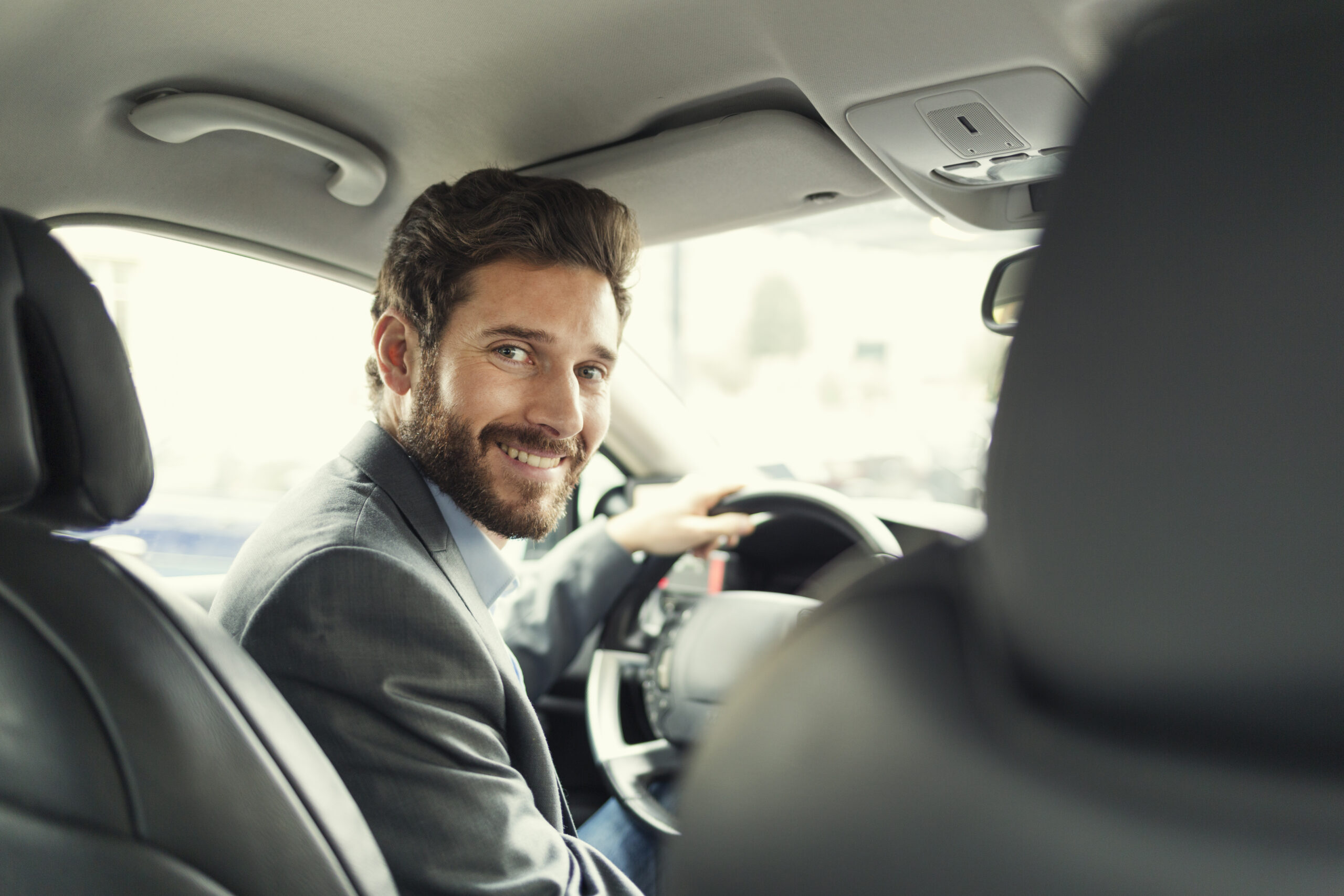 Portrait of man in his car. looking camera