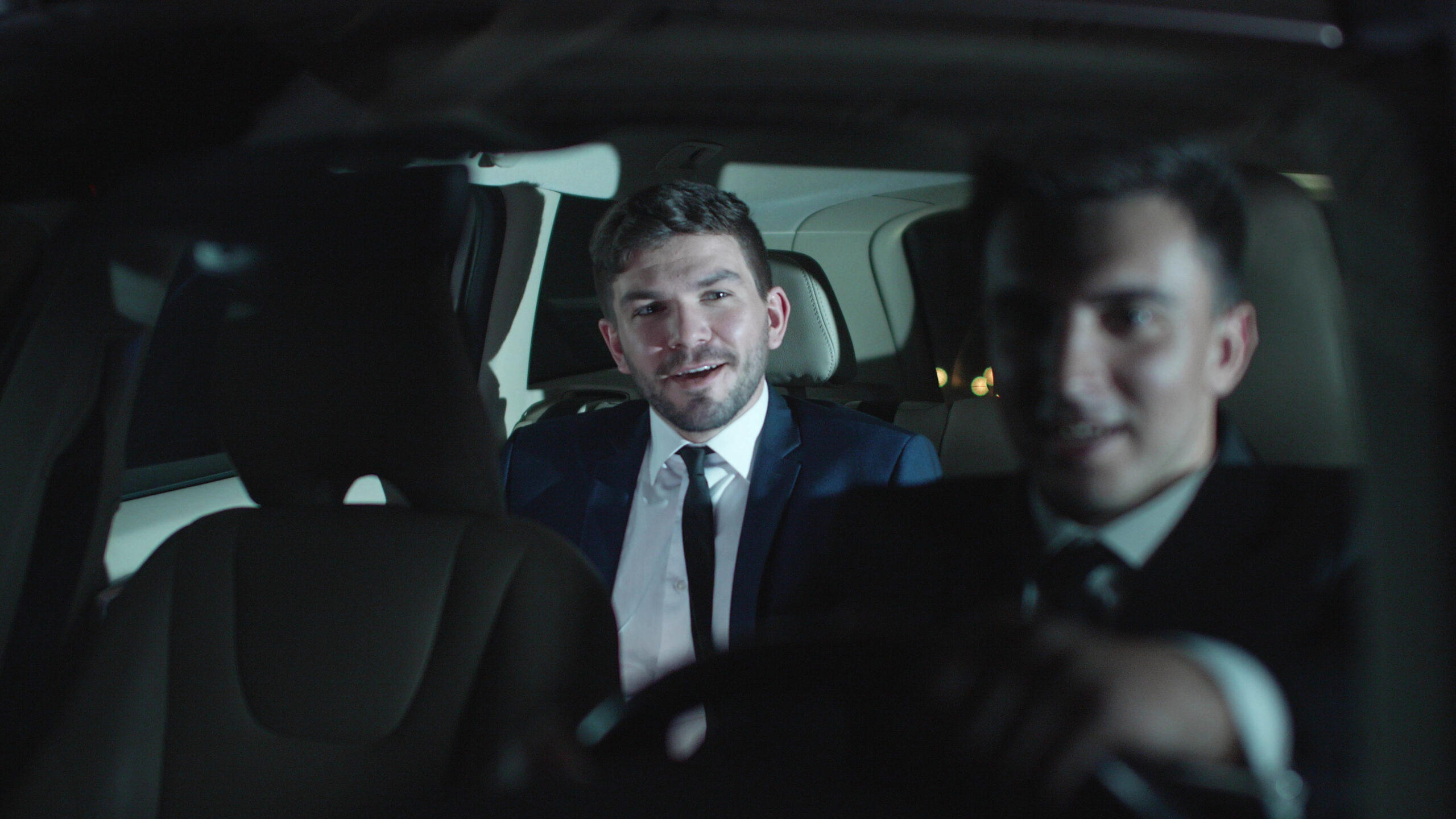 Two men drive in car and talk